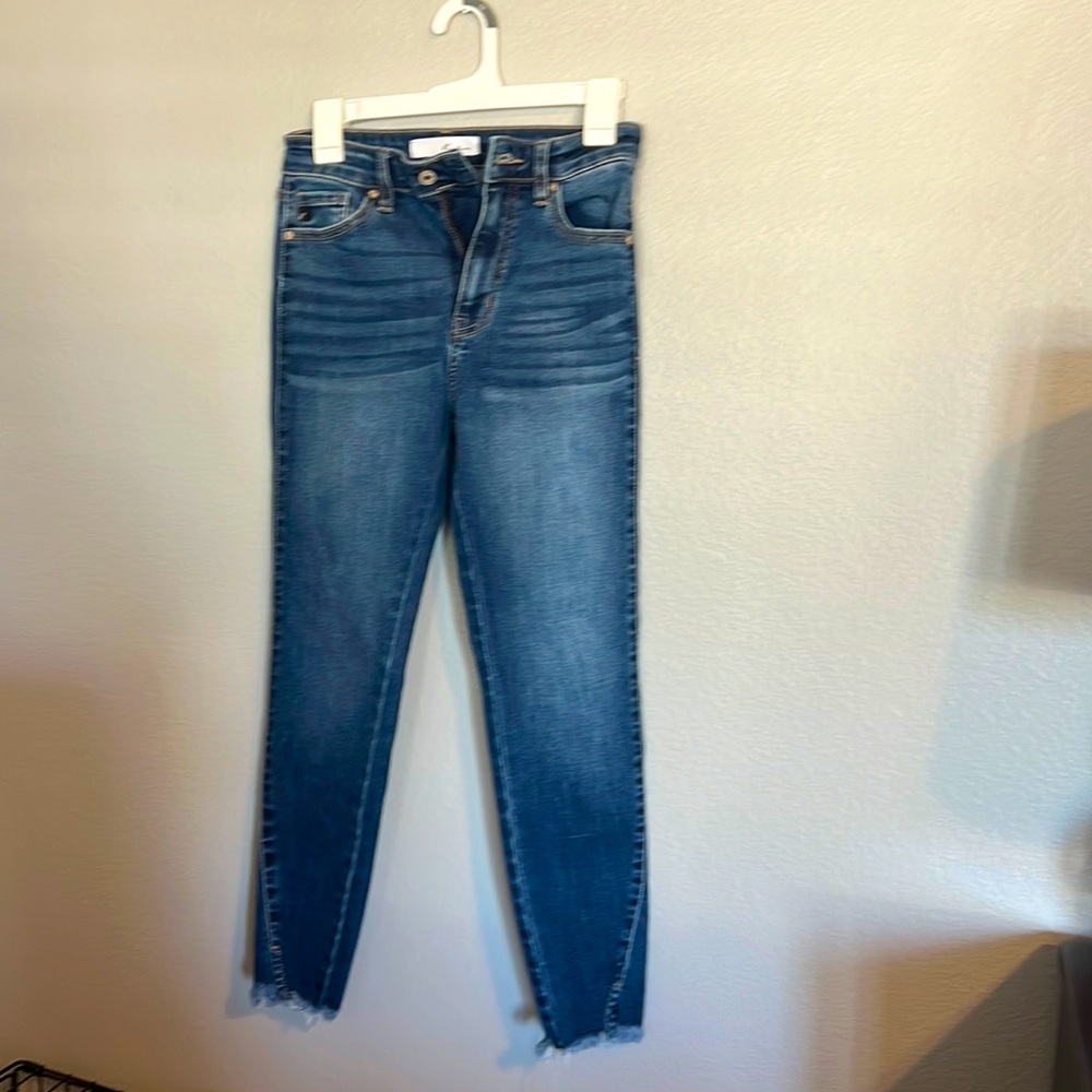 Like new Kancan skinny dark wash jeans with whiskering and raw hem details .